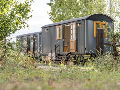 Two shepherd's huts with steps and garden benches at No 2 The Parkland Upton Warren