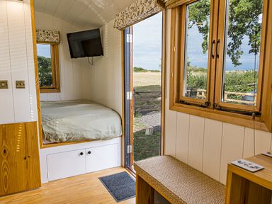 A bedroom with a bed and television at No 2 The Parkland in Upton Warren