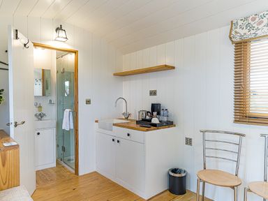 A kitchen area with a sink and kettle at No 2 The Parkland in Upton Warren