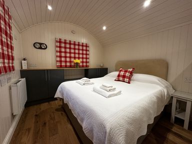 A bedroom with a bed and towels on it at The Lodge in Upton Warren