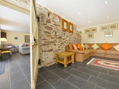 A living room with a sofa and coffee table at The Cider Barn at Home Farm Down Thomas near Wembury