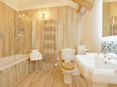 A bathroom with a shower and bathtub at The Cider Barn at Home Farm Down Thomas near Wembury