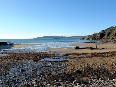 A beach with rocks and water at The Cider Barn at Home Farm Down Thomas near Wembury