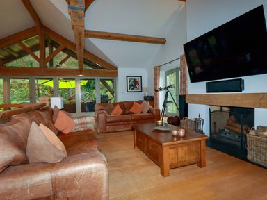 A living room with a sofa and coffee table at Kerslake House in Crafthole