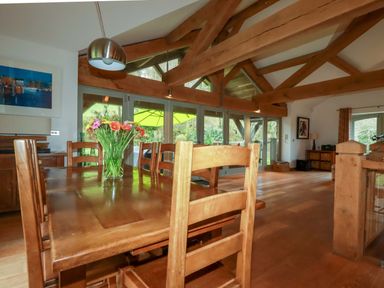 A dining room with a table and chairs at Kerslake House in Crafthole