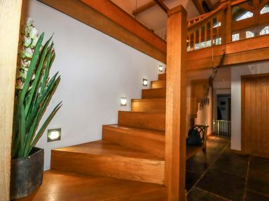 A hallway with stairs and a planter at Kerslake House, Crafthole