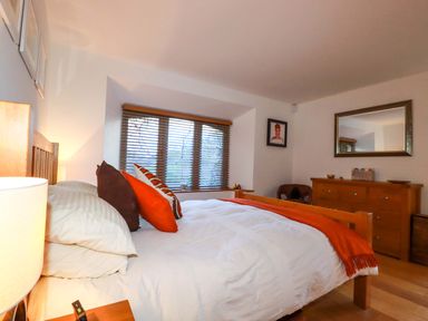 A bedroom with a bed and window at Kerslake House in Crafthole