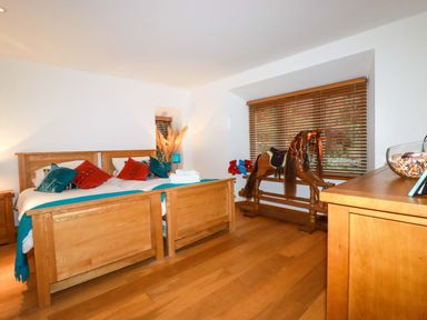 A bedroom with two beds and a rocking horse at Kerslake House in Crafthole