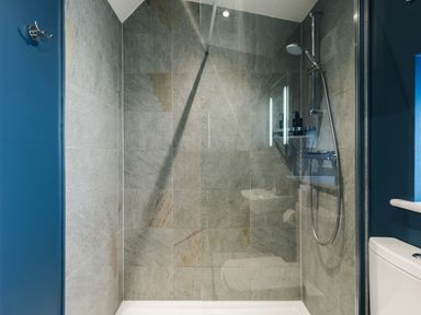A shower area with tiles and shower fixtures at The Lookout in Addingham