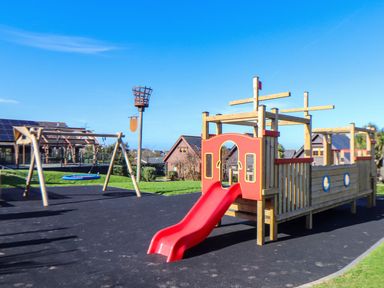A playground with a slide and swing set at Pentewan - 67 Portreath