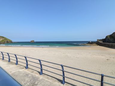 A beach with sand and sea at Pentewan - 67 Portreath