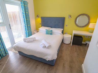 A bedroom with a bed and a desk at Pentewan - 67 in Portreath