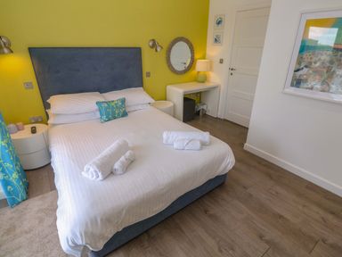 A bedroom with a bed and bedside table at Pentewan - 67 Portreath