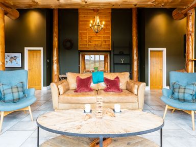 A living room with a sofa and chairs at Bears Den in Addingham