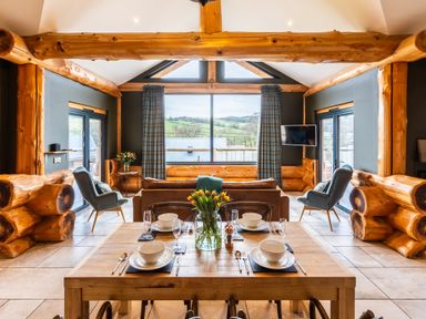 A living room with a dining table and chairs at Bears Den in Addingham