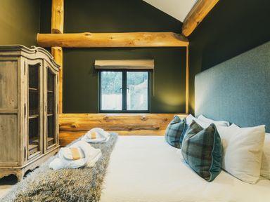 A bedroom with a bed and cabinet at Bears Den in Addingham
