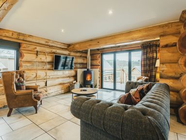 A living room with a sofa and armchair at Keepers Cabin in Addingham