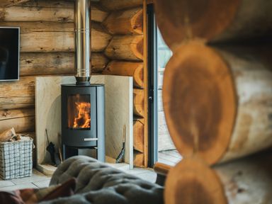 A living room featuring a fireplace and a television at Keepers Cabin in Addingham