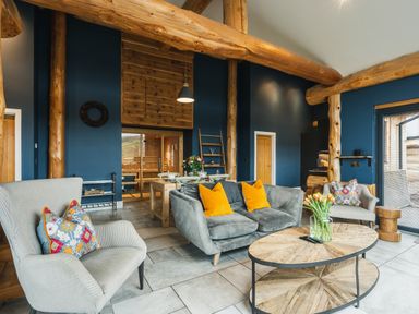 A living room with a sofa and chairs near a coffee table at The Farmhouse in Addingham