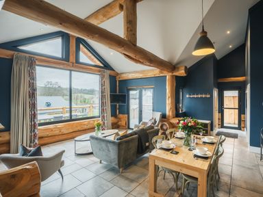 A living room with a sofa and dining table at The Farmhouse in Addingham