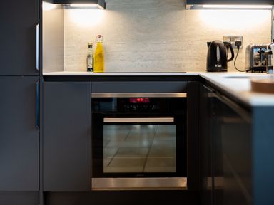 A kitchen with an oven, kettle, and olive oil at The Farmhouse in Addingham