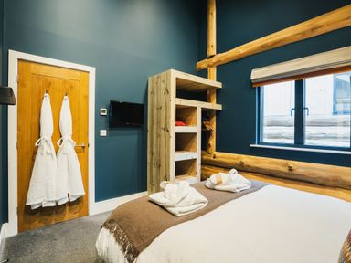 A bedroom with a bed and towels at The Farmhouse in Addingham