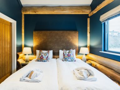 A bedroom with a bed and lamps at The Farmhouse in Addingham