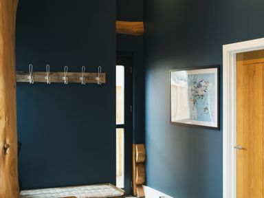 An entrance hall with a bench and coat hooks at The Farmhouse in Addingham