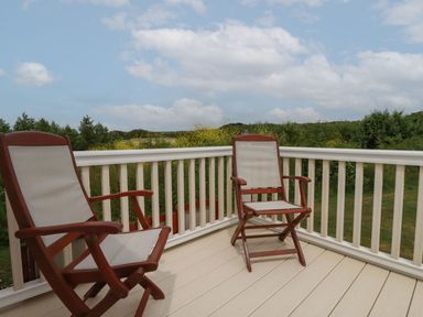 A deck area with two chairs and a view at No. 4 Fistral in Newquay