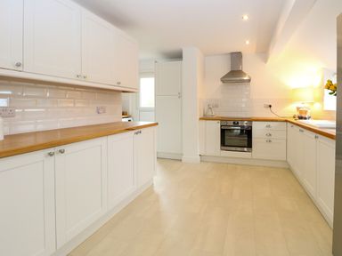 A kitchen with cabinets and appliances at Three Ways in South Lopham near Garboldisham