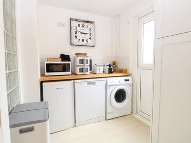 A laundry room with appliances on a countertop at Three Ways South Lopham near Garboldisham