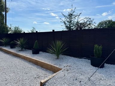 A garden with gravel and planters at Three Ways in South Lopham near Garboldisham