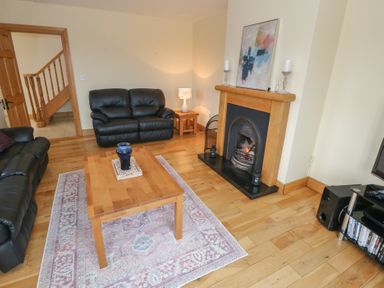 A living room with a fireplace and a coffee table at Tigh Marie