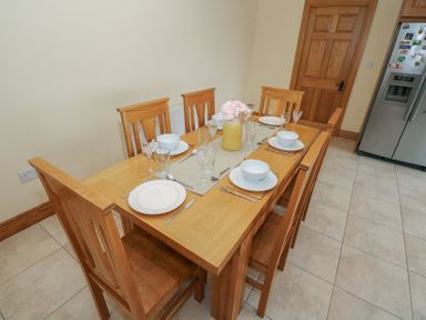 A dining table set with plates and glasses at Tigh Marie 