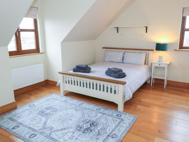 A bedroom with a bed and towels on top at Tigh Marie