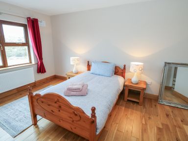 A bedroom with a bed and lamps at Tigh Marie