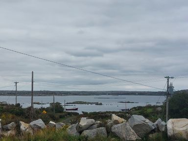 A view of water with boats and rocks at Tigh Marie