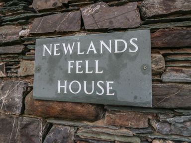 A stone sign displaying Newlands Fell House at Newlands near Keswick