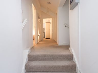 A hallway with stairs leading to rooms at Newlands Fell House near Keswick