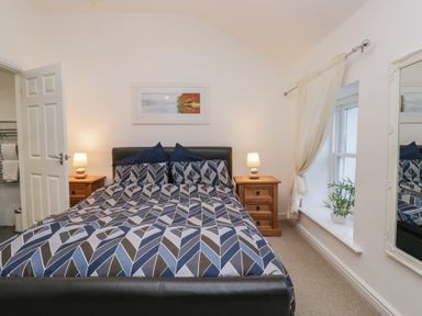 A bedroom with a bed and bedside table at Newlands Fell House near Keswick