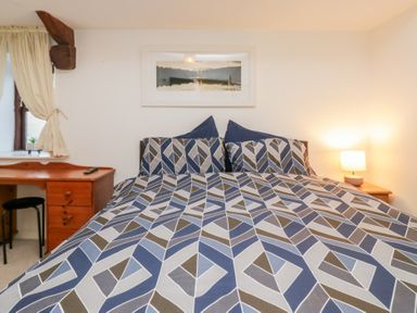 A bedroom with a bed and desk at Newlands Fell House in Newlands near Keswick