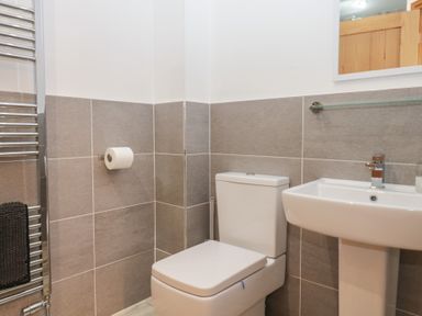 A bathroom with a toilet and sink at Newlands Cottage in Keswick