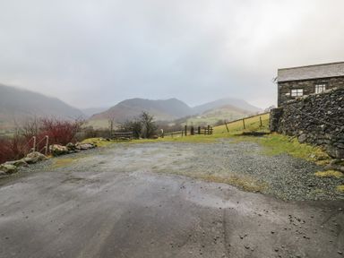 A landscape with mountains and a building at Newlands Cottage Keswick
