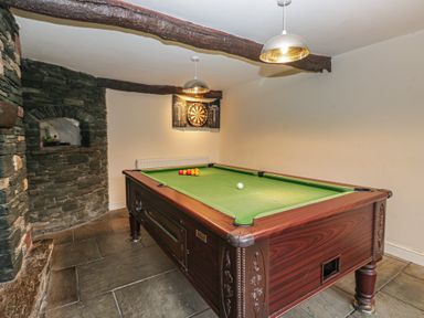A games room with a snooker table and a darts board at Birkbank Farm Cockermouth