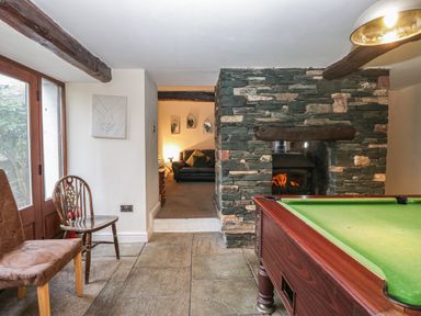 A snug with a pool table and leather sofa at Birkbank Farm Cockermouth