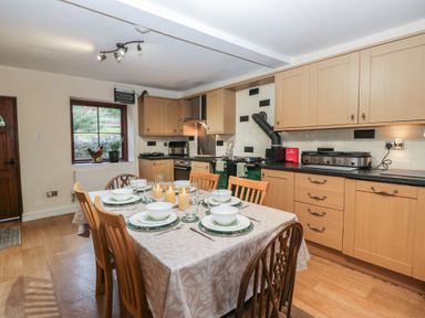 A kitchen with a dining table set at Birkbank Farm in Cockermouth
