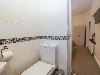 A bathroom with a toilet and sink at Birkbank Farm Cockermouth
