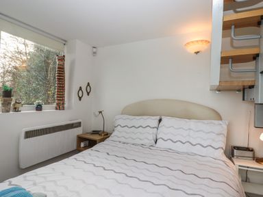 A bedroom with a bed and decorative items at The Old Telephone Exchange Exeter