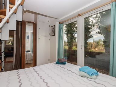 A bedroom with towels on a bed and a staircase at The Old Telephone Exchange in Exeter