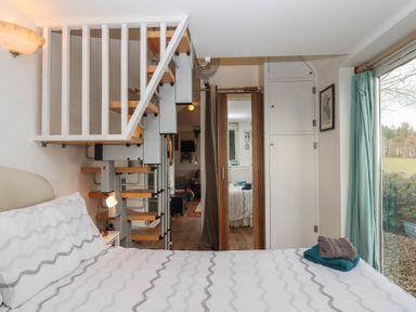 A bedroom with a bed and stairs at The Old Telephone Exchange Exeter